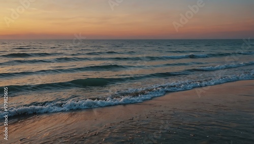 Pastel sky and calm ocean at sunset with sparkling waves.