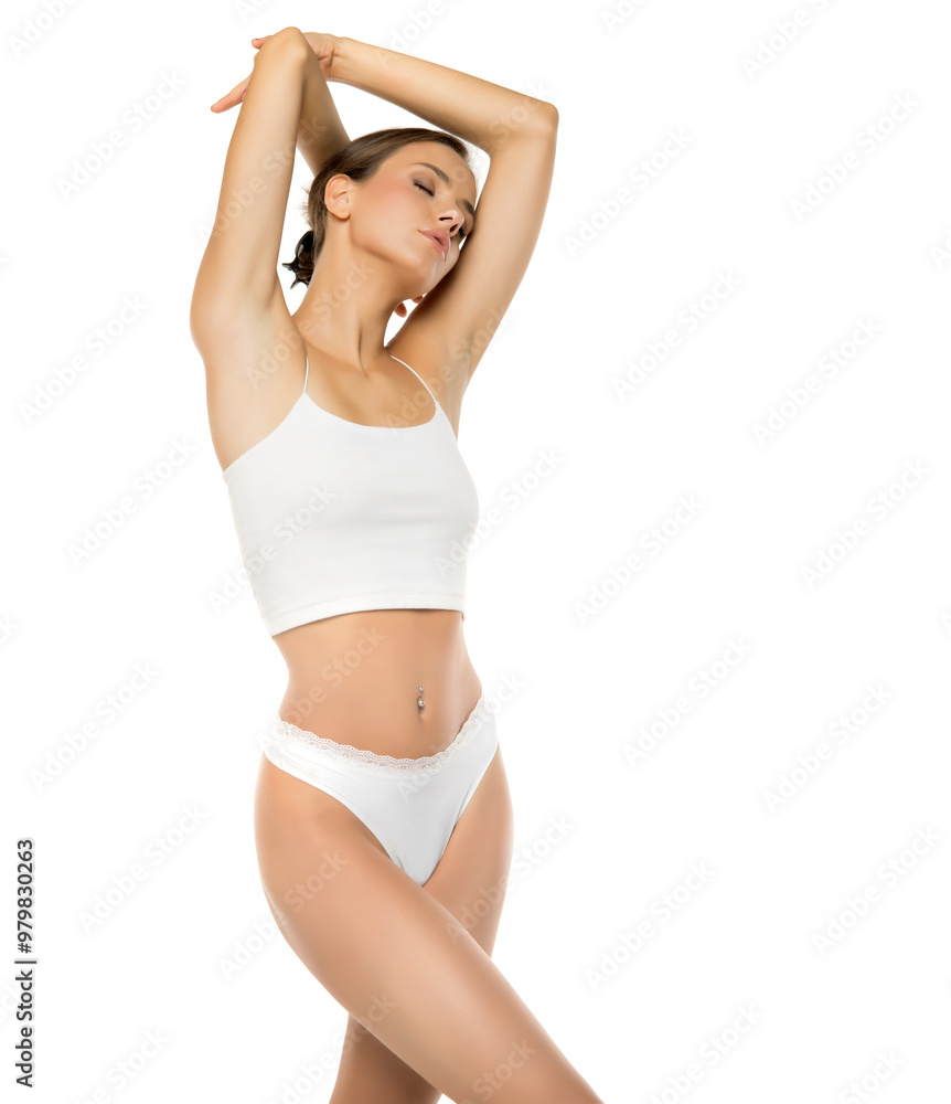 Close up shot of beautiful young fit woman in lingerie isolated on white background. Torso of slim attractive female with flat belly in white underwear Close up shot of beautiful young fit woman in lingerie isolated on white background. Torso of slim attractive female with flat belly in white underwear