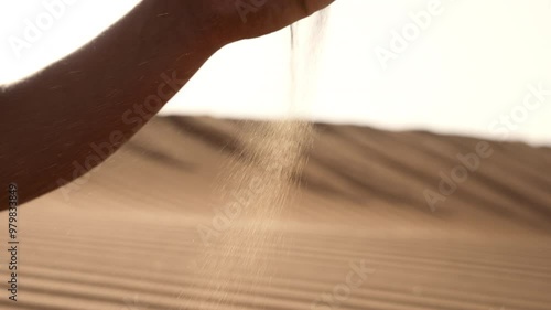 Wallpaper Mural Close up slow motion view of a male hand grabbing grains of sand from the desert Torontodigital.ca