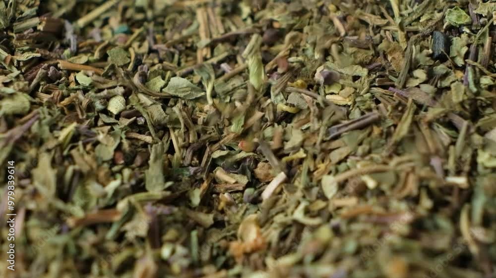 Macro slow motion pouring dried basil seasoning. Macro slow motion pouring dried basil seasoning.
