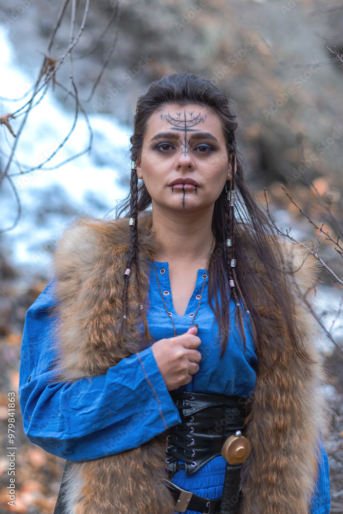 Viking warrior girl in blue in autumn Viking warrior girl in blue in autumn