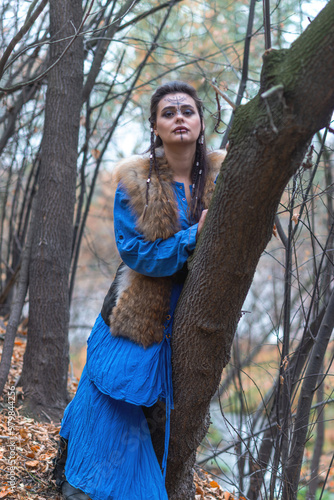 Viking warrior girl in blue in autumn