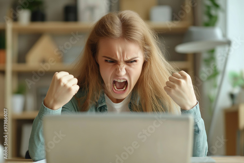 angry woman in front of laptop in rage