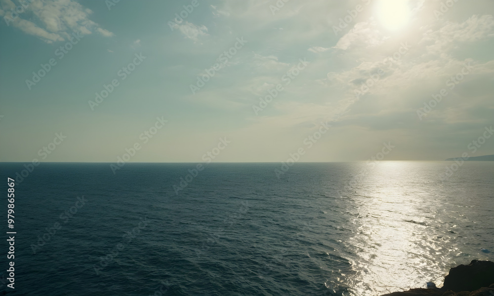 Sun shining on calm ocean water on cloudy day Sun shining on calm ocean water on cloudy day