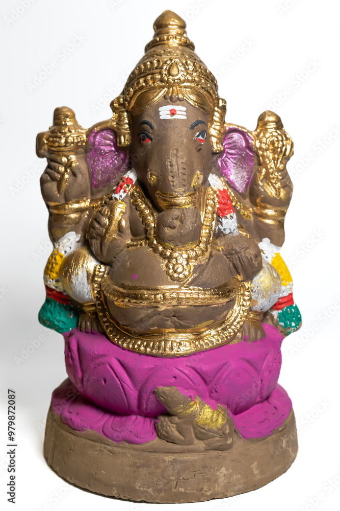 Ganesha idol made of painted clay on white background. Vertical Shot Ganesha idol made of painted clay on white background. Vertical Shot