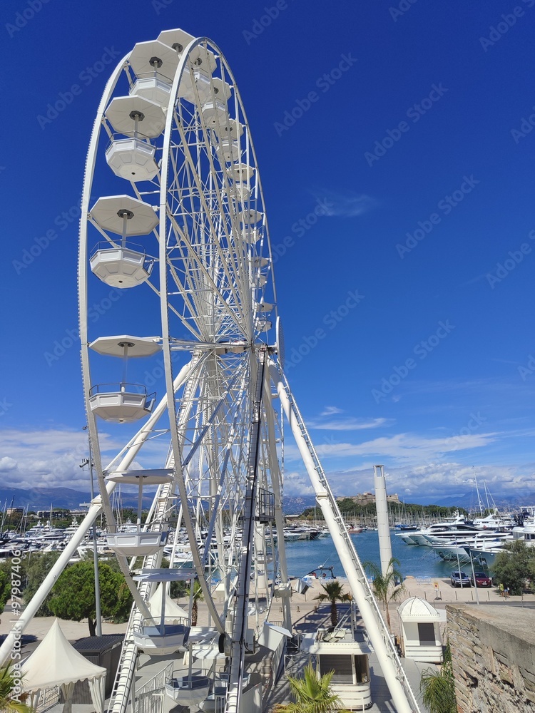 A beautiful scenic view featuring a Ferris wheel located at the Marina under a clear blue sky A beautiful scenic view featuring a Ferris wheel located at the Marina under a clear blue sky