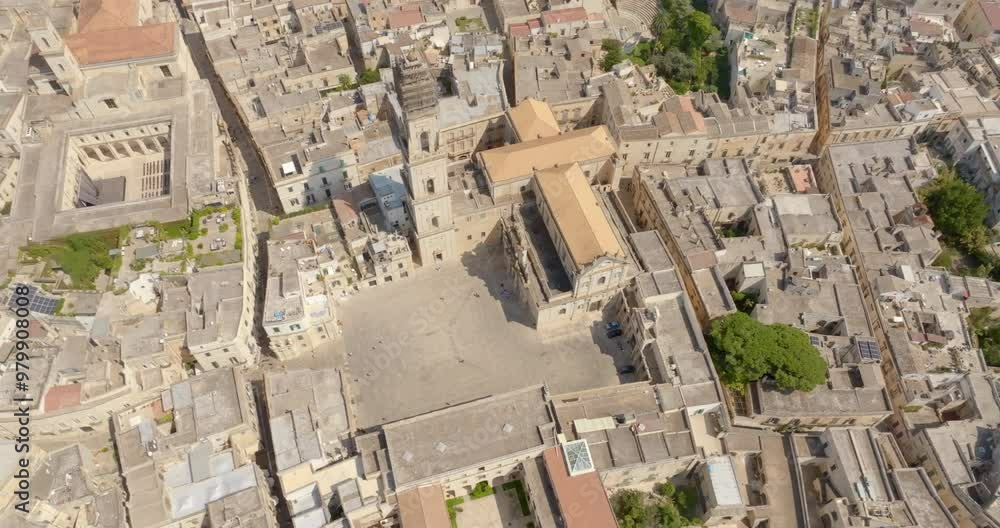 Aerial view of the cathedral of Lecce, in Apulia, Italy. The metropolitan cathedral of Santa Maria Assunta with its tall bell tower is located in Piazza del Duomo, in the historic center of the city. Aerial view of the cathedral of Lecce, in Apulia, Italy. The metropolitan cathedral of Santa Maria Assunta with its tall bell tower is located in Piazza del Duomo, in the historic center of the city.