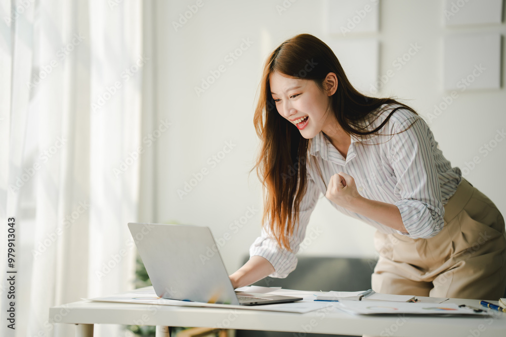 Beautiful Asian woman is very excited to close a sale. The young woman is smiling and happy about the successful project. Beautiful Asian woman is very excited to close a sale. The young woman is smiling and happy about the successful project.