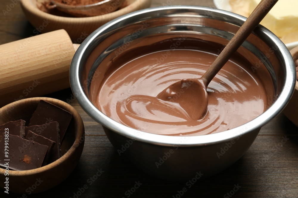 Chocolate dough in bowl and ingredients on wooden table, closeup Chocolate dough in bowl and ingredients on wooden table, closeup