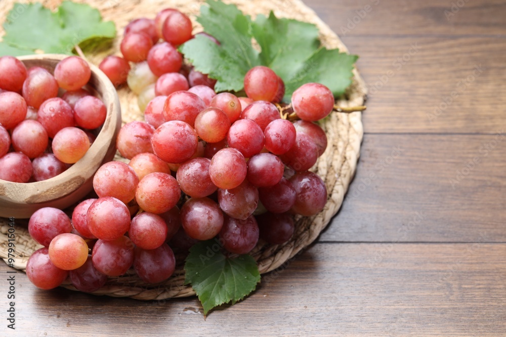Delicious fresh ripe grapes on wooden table Delicious fresh ripe grapes on wooden table