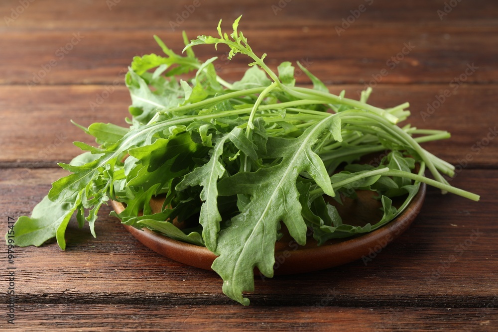 Fresh green arugula leaves on wooden table, closeup Fresh green arugula leaves on wooden table, closeup