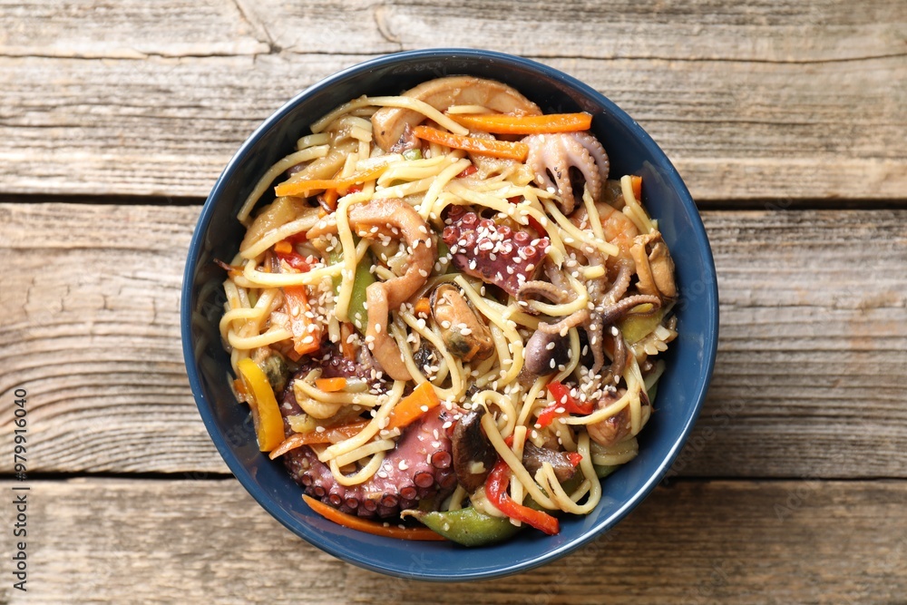 Stir-fry noodles with sea food and vegetables on wooden table, top view Stir-fry noodles with sea food and vegetables on wooden table, top view