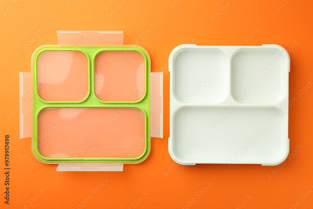 One empty lunch box on orange background, flat lay One empty lunch box on orange background, flat lay