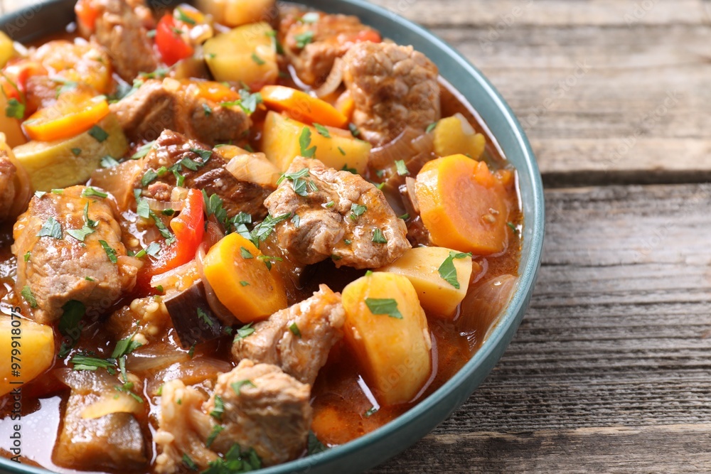 Delicious stew with vegetables on wooden table, closeup Delicious stew with vegetables on wooden table, closeup