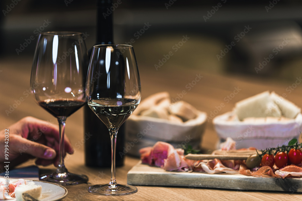 People drinking wine and eating cold cut meat in a wine cellar. People drinking wine and eating cold cut meat in a wine cellar.