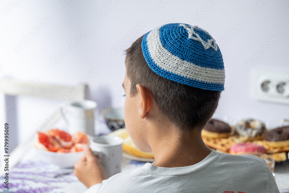 jewish family celebrating hanukkah, israel, boy in kippah, jewish holidays, yom kippur feast, table with food, honey, donuts, family holiday jewish family celebrating hanukkah, israel, boy in kippah, jewish holidays, yom kippur feast, table with food, honey, donuts, family holiday