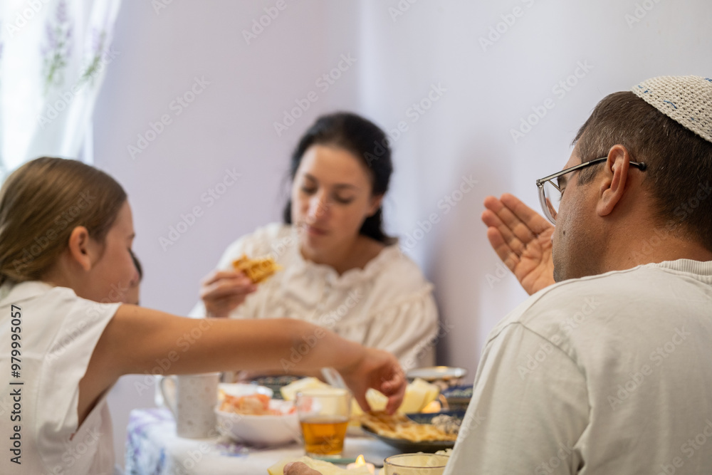 jewish family celebrating hanukkah, israel, boy in kippah, jewish holidays, yom kippur feast, table with food, honey, donuts, family holiday jewish family celebrating hanukkah, israel, boy in kippah, jewish holidays, yom kippur feast, table with food, honey, donuts, family holiday