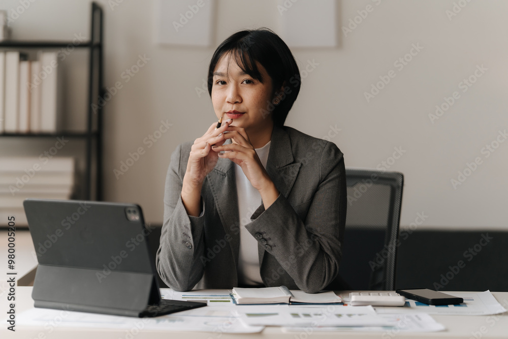 Strategic Thinking: Young Asian Businesswoman Analyzing Data Strategic Thinking: Young Asian Businesswoman Analyzing Data