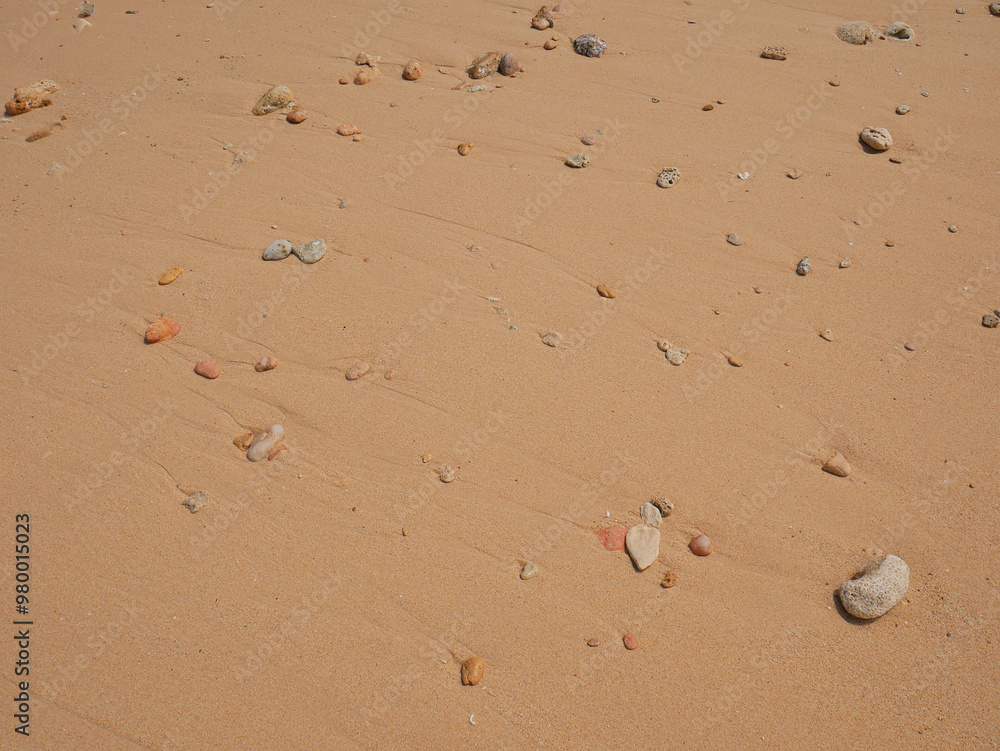 Background of rocks and pink sand on the beach seashore