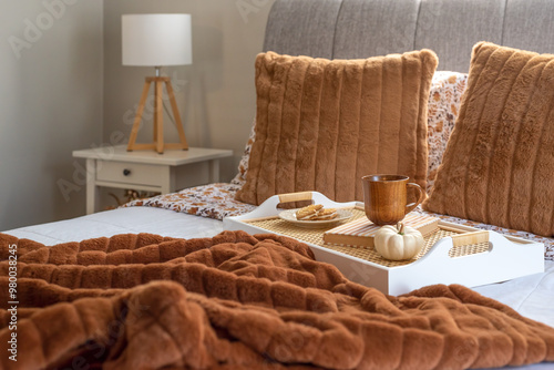 Tray with cookies and a hot drink in a cozy fall bedroom