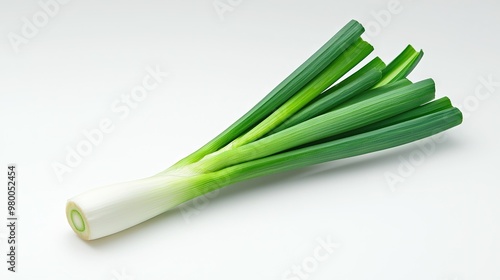   Close-up of green onions on white surface with visible green stem