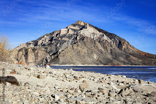 Cedar Mountain and the Buffalo Bill Reservoir in spring with blue sky and white clouds outside of Cody Wyoming, USA 