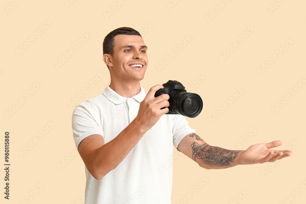 Male photographer with modern camera on beige background Male photographer with modern camera on beige background
