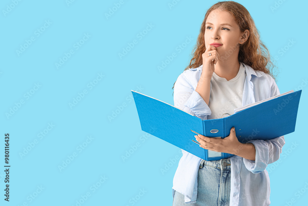 Thoughtful young woman with document folder on blue background
