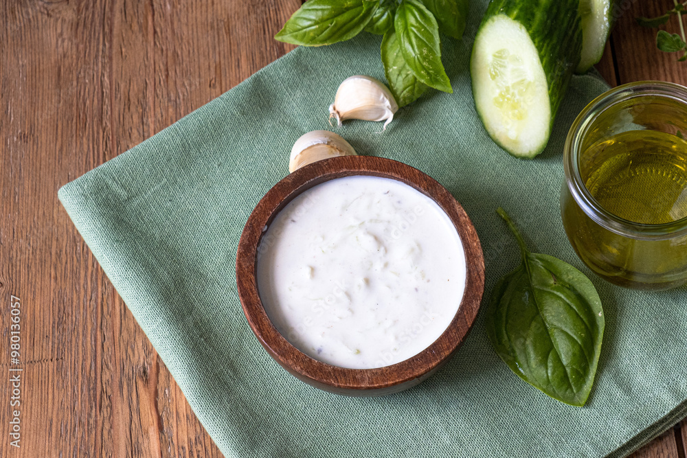 White dip sauce - sour cream or yogurt in wooden bowl. Greek sauce White dip sauce - sour cream or yogurt in wooden bowl. Greek sauce