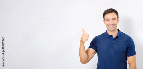 A portrait of a man wearing a blue polo shirt, smiling and giving a thumbs-up.