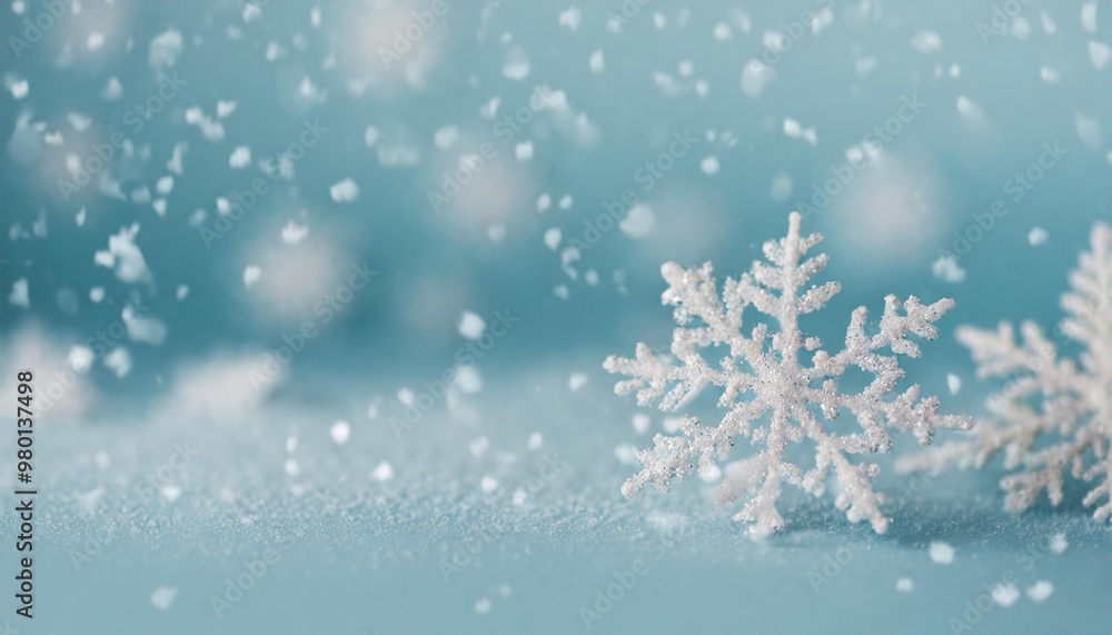 Minimalist winter background with depth of field featuring soft snowflakes on a light blue backdrop Minimalist winter background with depth of field featuring soft snowflakes on a light blue backdrop