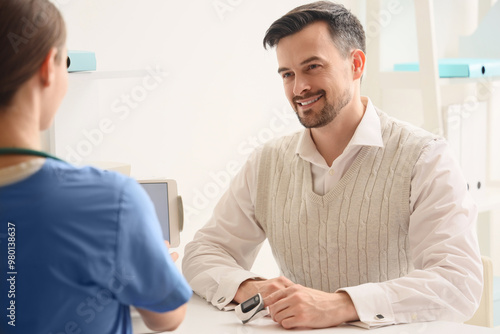 Young man with pulse oximet...