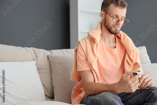 Young man with pulse oximet...