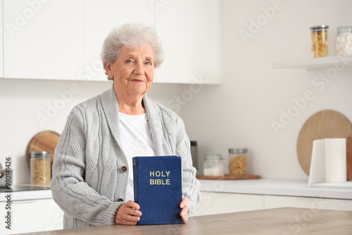 Elderly woman holding holy ...