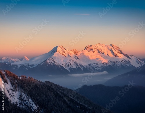 Serene snow-capped peaks at sunrise with golden light touching the mountain tops