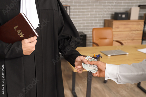Schilderij op canvas Male judge with law book taking bribe from man in office, closeup