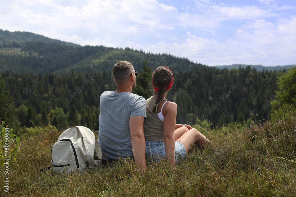 Couple with backpack enjoying picturesque landscape, back view. Active tourism Couple with backpack enjoying picturesque landscape, back view. Active tourism
