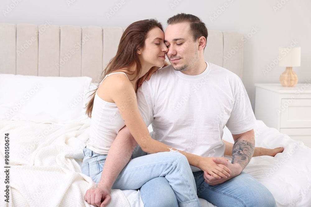Cute couple spending time together on bed at home Cute couple spending time together on bed at home