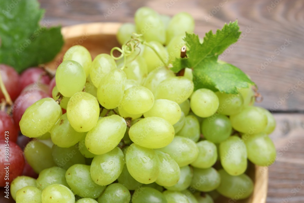 Fresh ripe grapes on wooden table, closeup Fresh ripe grapes on wooden table, closeup