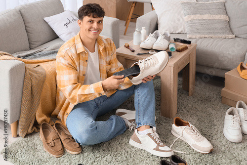 Young man putting insole in...