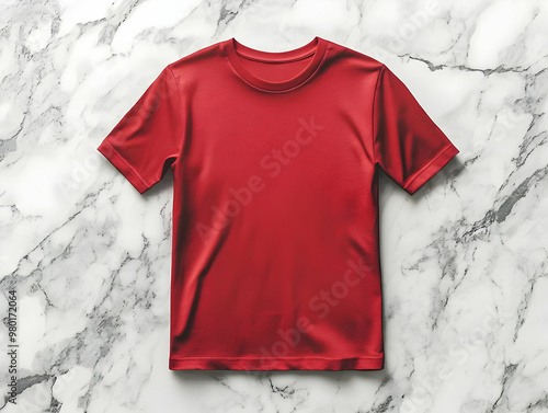 A vibrant red t-shirt displayed on a marble background, perfect for showcasing clothing designs and fashion concepts. photo