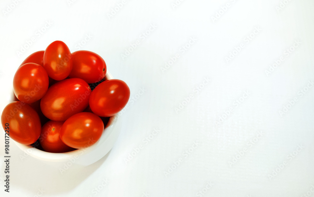 Isolated bowl full of ripe cherry tomatoes with copy space.
Isolated bowl full of ripe cherry tomatoes with copy space.