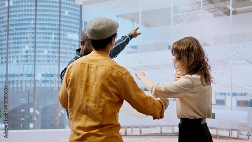 Valokuva Professional team touring an office space with real estate agent, evaluating building layout and discussing high class urban property investment