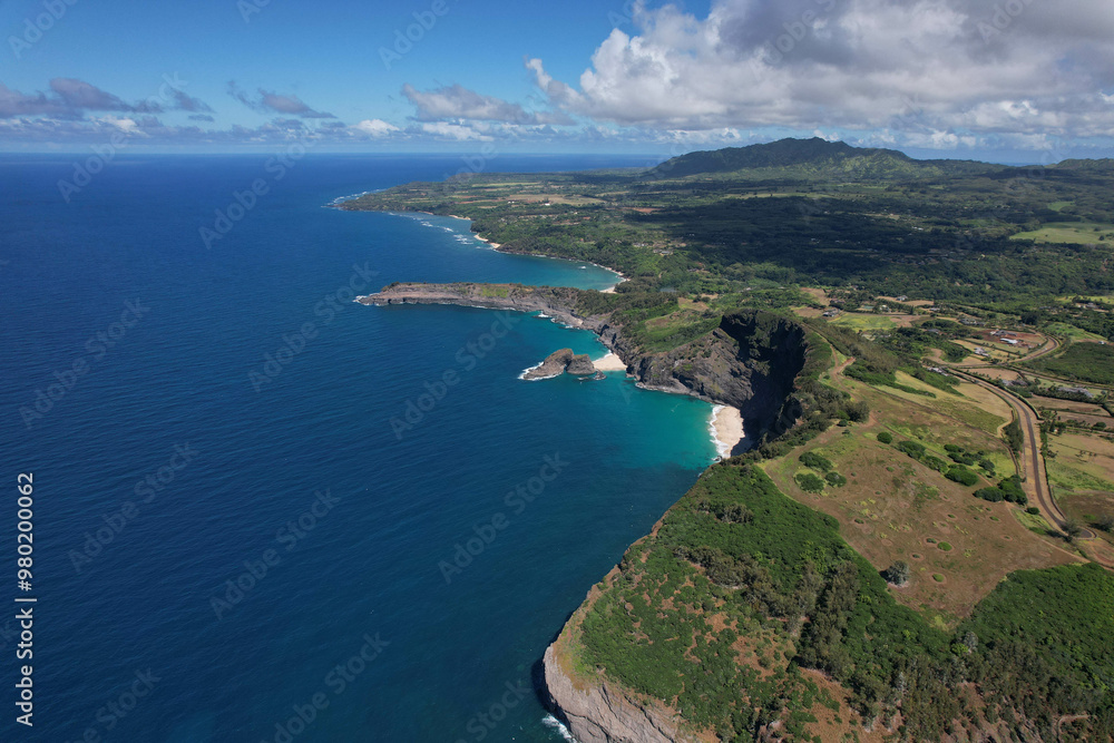 A stunning aerial view of a rugged coastline with clear blue waters. Perfect for travel, nature, and outdoor adventure projects, as well as editorial and tourism-related content. A stunning aerial view of a rugged coastline with clear blue waters. Perfect for travel, nature, and outdoor adventure projects, as well as editorial and tourism-related content.