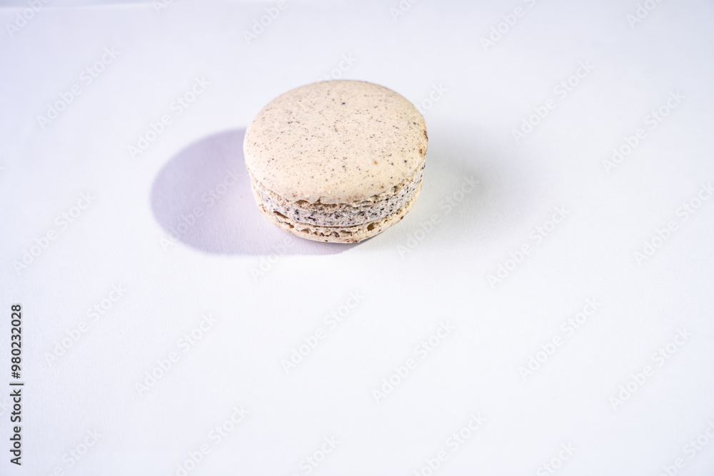 This is a French cookie called a macaron. It is two cookies made with meringue and cream sandwiched between them. This is a French cookie called a macaron. It is two cookies made with meringue and cream sandwiched between them.