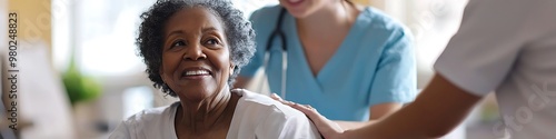 Nurse cares for a joyful senior black woman in a wheelchair, showing compassion.