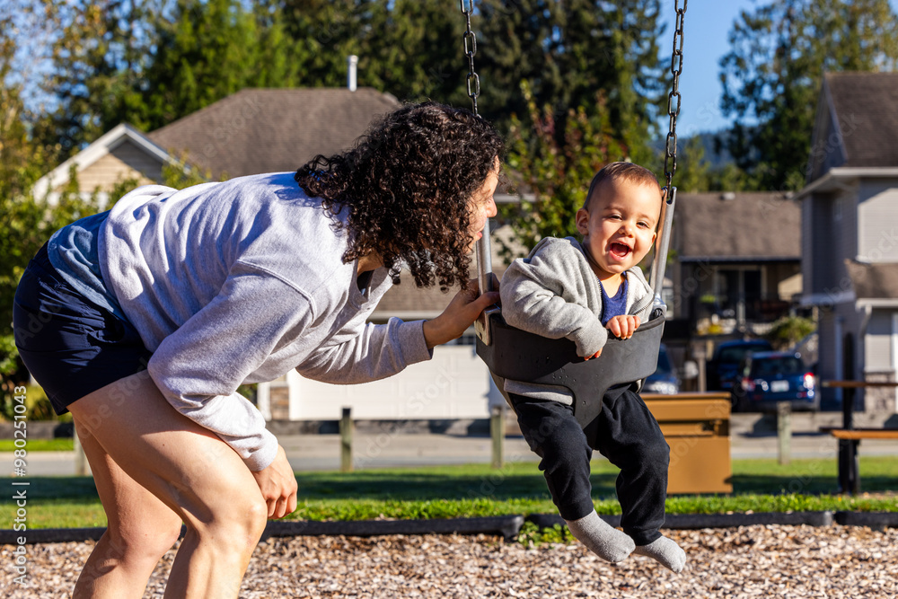 Naklejka premium Joyful Mother and Child Enjoying Playtime on Swing in Mission, BC, Canada Park