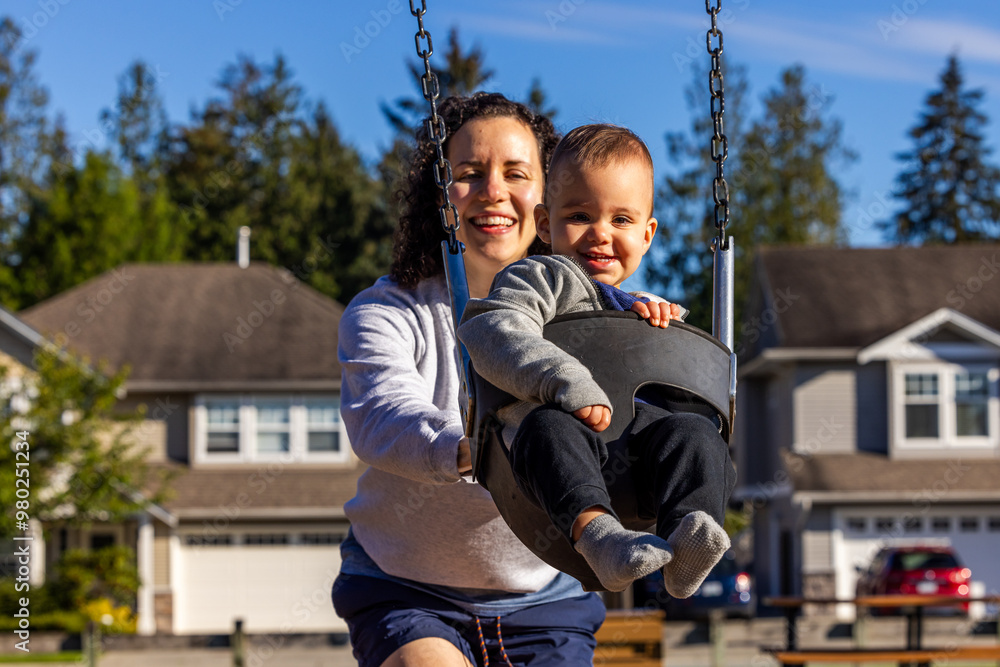 Obraz premium Mother and Child Enjoying Playtime on Swing Set in Mission, BC Neighborhood