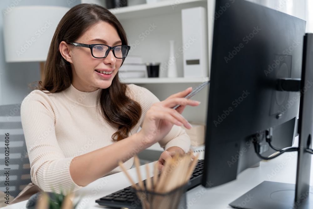Casual outfit smiling beautiful businesswoman wearing glasses looking report on pc, analyzing to create marketing plan to analyze new customer target with update promotion at modern office. Postulate. Casual outfit smiling beautiful businesswoman wearing glasses looking report on pc, analyzing to create marketing plan to analyze new customer target with update promotion at modern office. Postulate.
