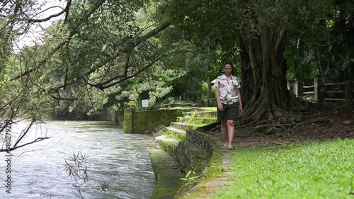 Wallpaper Mural Asian woman walking along the river in the forest Torontodigital.ca